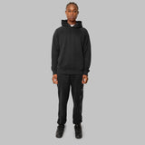 Front view of model. Full black hemp tracksuit. Black hemp hoodie. Black hemp joggers. Sustainable hemp clothing
