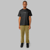 Full set of black hemp t-shirt and olive green hemp sweatpants. front view of model. sustainable street style.