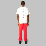 Complete set of white hemp t-shirt and red hemp sweatpants. Back view. Black 7319 embroidery along spine of white t-shit. Sustainable street fashion.