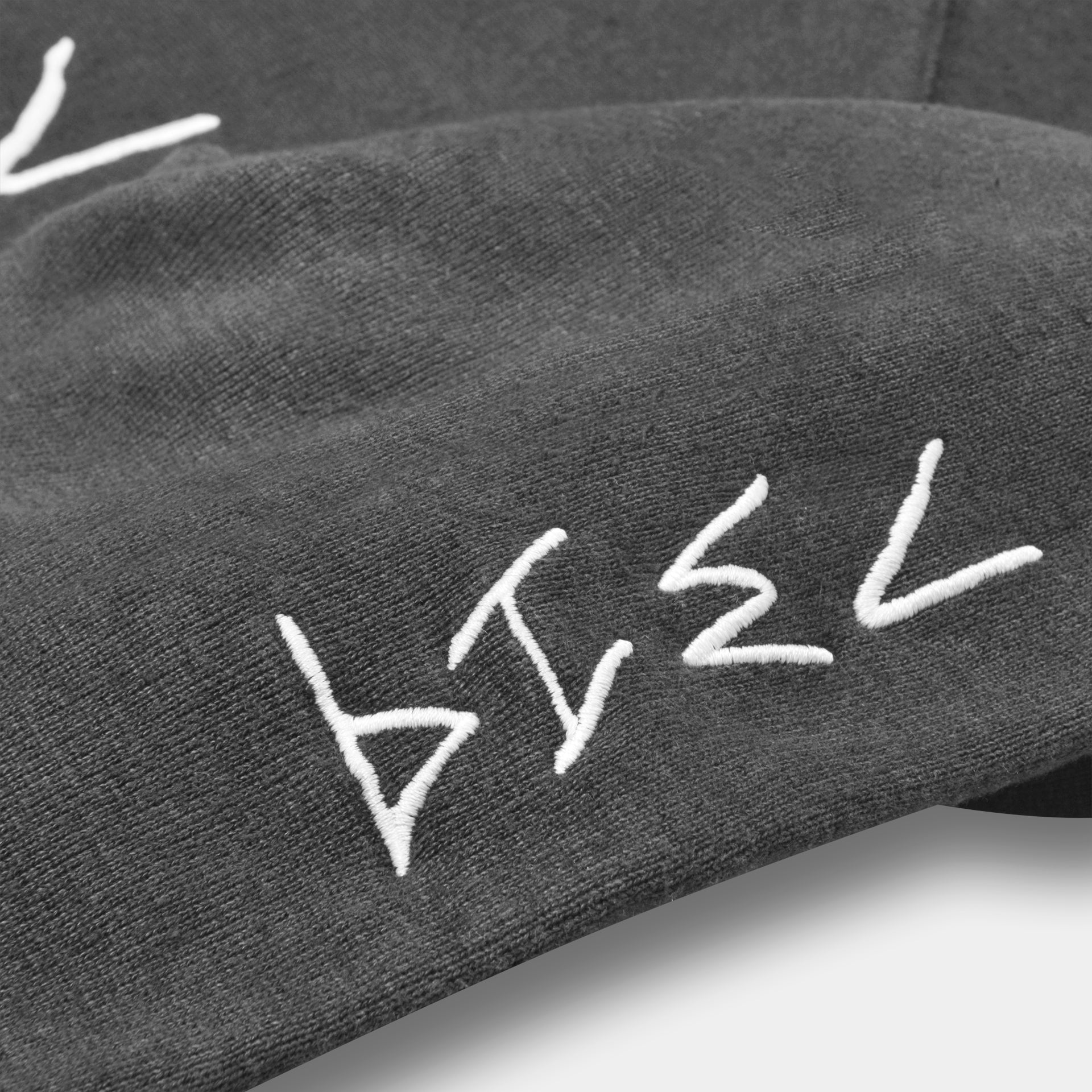Charcoal grey hemp hoodie. Close up of white embroidered 7319 logo. High quality natural organic materials. 