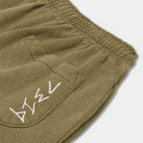 Olive green hemp joggers. Zoomed in image of back pocket. White logo detailed down right side of back pocket. Sustainable, stylish hemp clothing. 